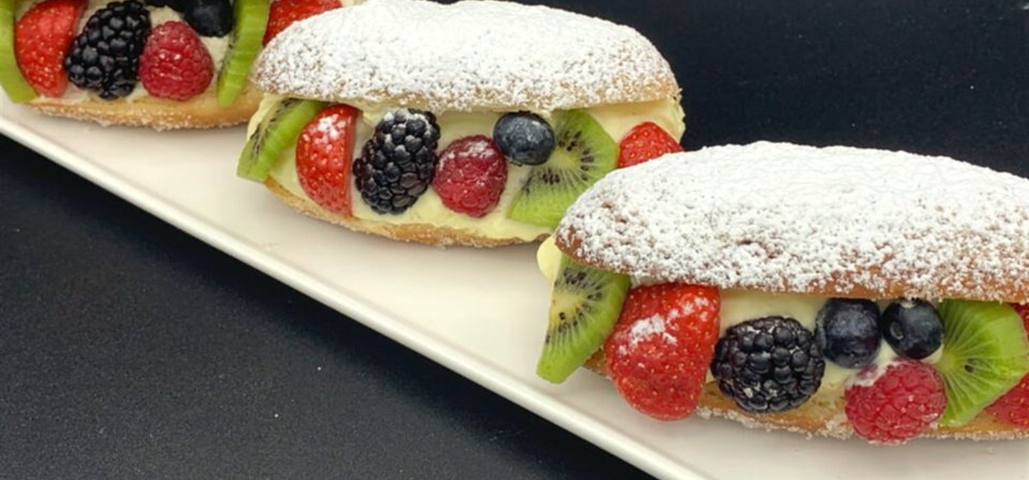Fresh fruit tarts topped with strawberries, kiwi, blackberries and blueberries