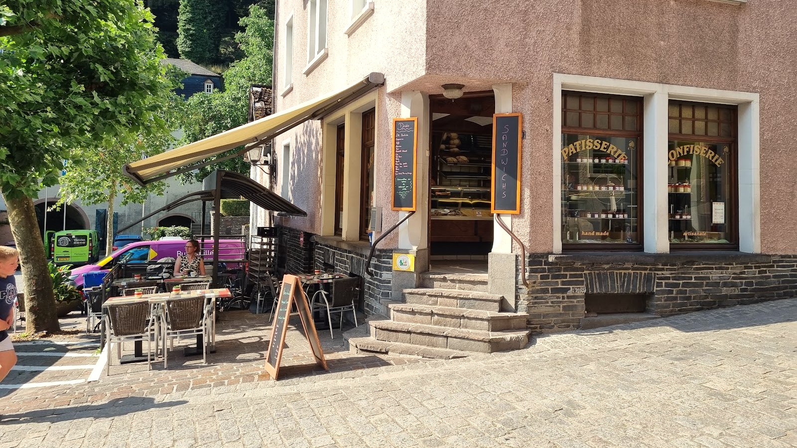 Au Croissant d'Or storefront and terrace seating on Grand-Rue, Vianden