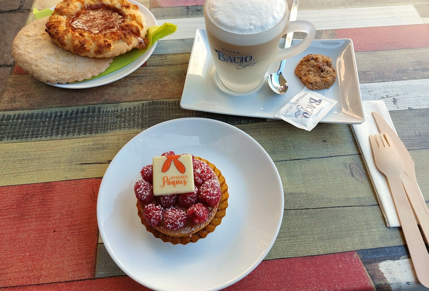 Coffee and pastry breakfast on a colourful wooden table